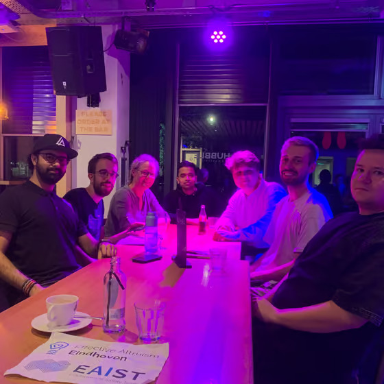 EA Eindhoven members gathered around a table at a social meetup